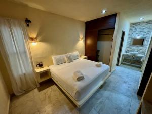 a bedroom with a white bed and a window at Jardín del Mar by ÓOL Hotels in Holbox Island +57 photos