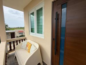 a porch with a chair and a wooden door at Monterosso By Cinque Terre in Isabela