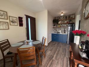 a kitchen and dining room with a table and chairs at Monterosso By Cinque Terre in Isabela