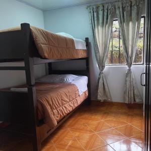 a bedroom with two bunk beds and a window at Casa la Colina in Macanal +22 photos
