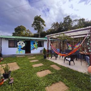 a house with a hammock in the yard at Casa la Colina in Macanal