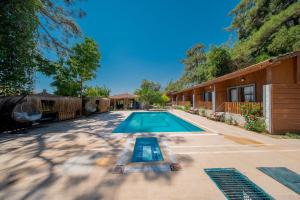 a swimming pool in a yard next to a house at Forest Garden in Goynuk