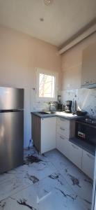 a kitchen with a sink and a refrigerator at Imeros Summer Home 3 in Ímeros