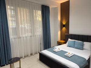 a bedroom with a large bed with blue pillows at Hotel Majestic in Struga