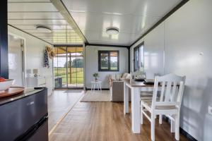 a kitchen and dining room with a table and chairs at Fajny domek Wójcice in Otmuchów