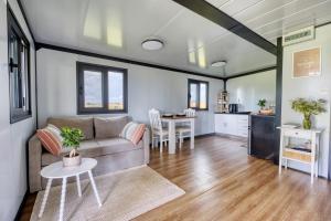 a living room with a couch and a table at Fajny domek Wójcice in Otmuchów +17 photos