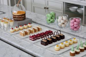 a buffet with different types of desserts and cakes at Address Boulevard in Dubai