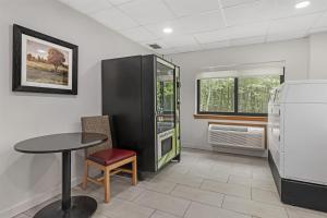 a dining room with a table and a refrigerator at Best Western Plus Brunswick Bath in Brunswick