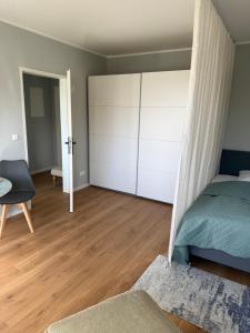 a bedroom with a bed and a white closet at ZV38-Mammut-30 in Salzgitter