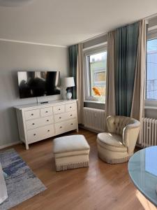 a living room with a tv and a chair and a table at ZV38-Mammut-30 in Salzgitter