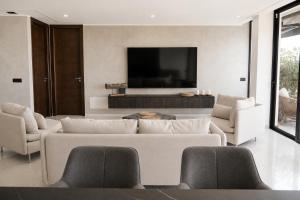 a living room with a couch and a flat screen tv at Villa de Anna in Adeje