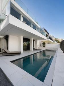 a swimming pool in front of a house at Villa de Anna in Adeje