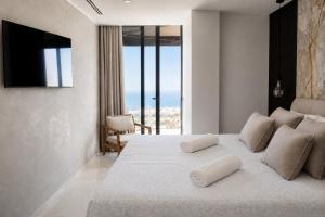 a bedroom with a large bed with a view of the ocean at Villa de Anna in Adeje +30 photos