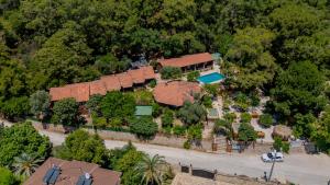 an aerial view of a house with a fence at Forest Garden in Goynuk