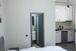 a kitchen with white cabinets and a black door at Creative hotel in Gyumri +38 photos