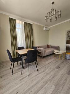 a living room with a table and chairs and a couch at Creative hotel in Gyumri
