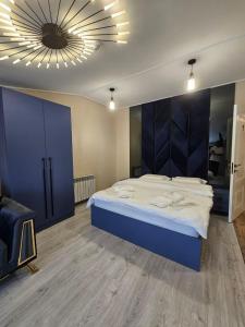 a bedroom with a large bed with a blue headboard at Creative hotel in Gyumri