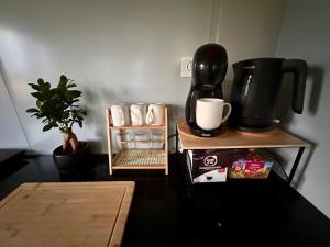 a table with a coffee maker on top of it at Fajny domek Wójcice in Otmuchów