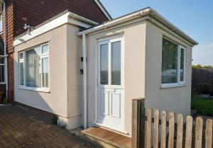 a house with a white door and a fence at Castle View Dover in Dover