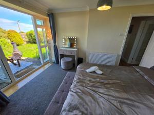 a bedroom with a bed and a large window at Castle View Dover in Dover