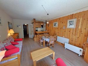 a living room with a couch and a table at Studio 4 pers, centre station Les Deux Alpes, animaux admis - FR-1-516-75 in Les Deux Alpes