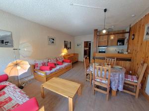a living room with a couch and a table at Studio 4 pers, centre station Les Deux Alpes, animaux admis - FR-1-516-75 in Les Deux Alpes
