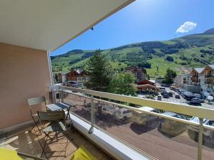 a balcony with a view of a city at Studio 4 pers, centre station Les Deux Alpes, animaux admis - FR-1-516-75 in Les Deux Alpes