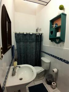 a bathroom with a sink and a toilet at GuacamayaGuestHouse in Concepción de Ataco