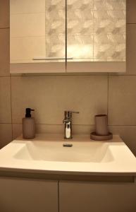 a white sink in a kitchen with a counter top at Lazatka in Samothraki