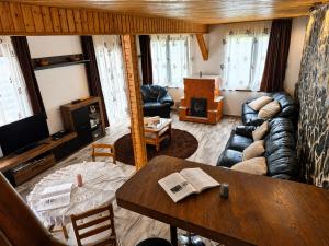 a living room with a couch and a table at Coco & Simi Lakeside Nest in Cinciş