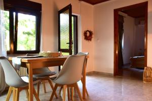 a dining room with a wooden table and chairs at Lazatka in Samothraki +18 photos