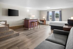 a hotel room with a bed and a desk at Days Inn by Wyndham Mt. Vernon in Mount Vernon