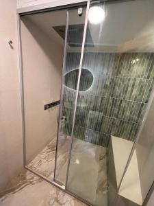 a shower with a glass door in a bathroom at Villa Sakura in Lindos +33 photos