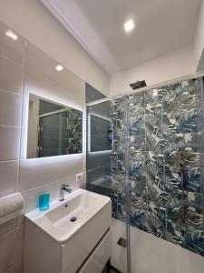 a bathroom with a sink and a shower at Capri House - camera Luna Caprese in Minori +15 photos