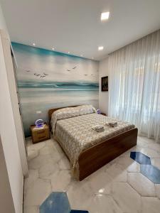 a bedroom with a bed and a painting on the wall at Capri House - camera Luna Caprese in Minori