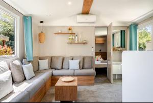 a living room with a couch and a table at Le petit paradis du golfe in Gassin +10 photos