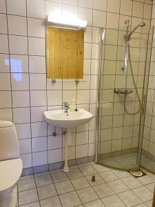 a bathroom with a sink and a shower at Svenningdal Camping in Svenningdal +39 photos