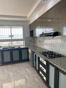 a kitchen with a stove and a counter top at Ain grenz in Kelibia