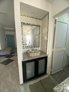 a bathroom with a sink and a mirror at Ain grenz in Kelibia +16 photos
