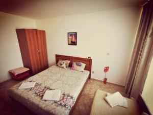 a small bedroom with two beds and a cabinet at Apartment Blue Komfort in Sunny Beach +14 photos