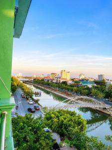 a view of a river with a bridge and a city at ĐAN MY Motel in Dong Hoi