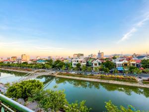 a city with a river and a bridge at ĐAN MY Motel in Dong Hoi +2 photos
