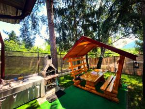 a backyard with a play house and an outdoor oven at Kuća za odmor sa bazenom Aria in Potkraj