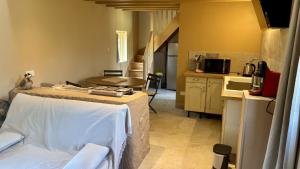 a small kitchen with a table and a counter top at À la Pays Anes in Tannerre-en-Puisaye