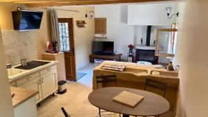 a kitchen with a table and a kitchen with a sink at À la Pays Anes in Tannerre-en-Puisaye