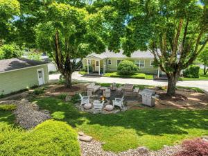 a backyard with a fire pit and two trees at Black Mountain Bungalow Steps to Town Backyard in Black Mountain