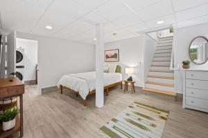 a bedroom with a bed and a staircase at Black Mountain Bungalow Steps to Town Backyard in Black Mountain