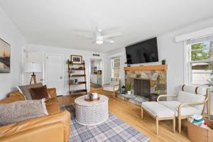 a living room with a couch and a fireplace at Black Mountain Bungalow Steps to Town Backyard in Black Mountain