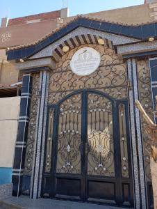 a door to a building with a sign on it at Heaven 2 in Mīt Abū Shaykhah