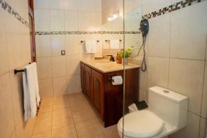 a bathroom with a toilet and a sink at Green Forest Rustic Houses in Monteverde Costa Rica +9 photos